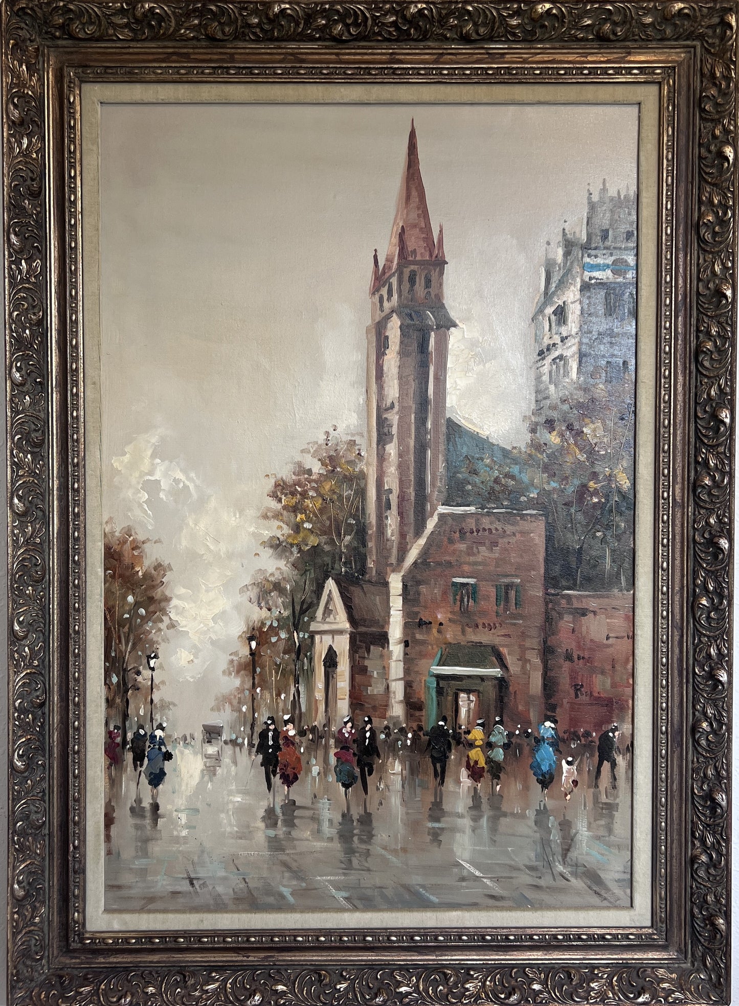 A large canvas painting by artist Antonio De Vity depicting a Paris street view, framed in an ornate gild frame.
