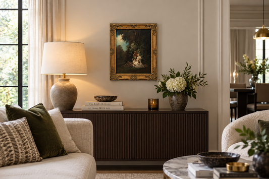 Antique oil painting in ornate gilt frame displayed in a modern neutral living room interior.